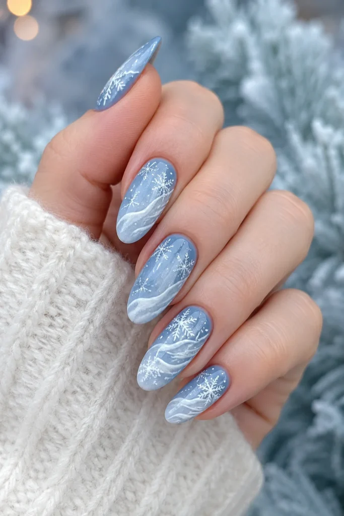 Layered white snowdrift details over a cool icy blue nail base