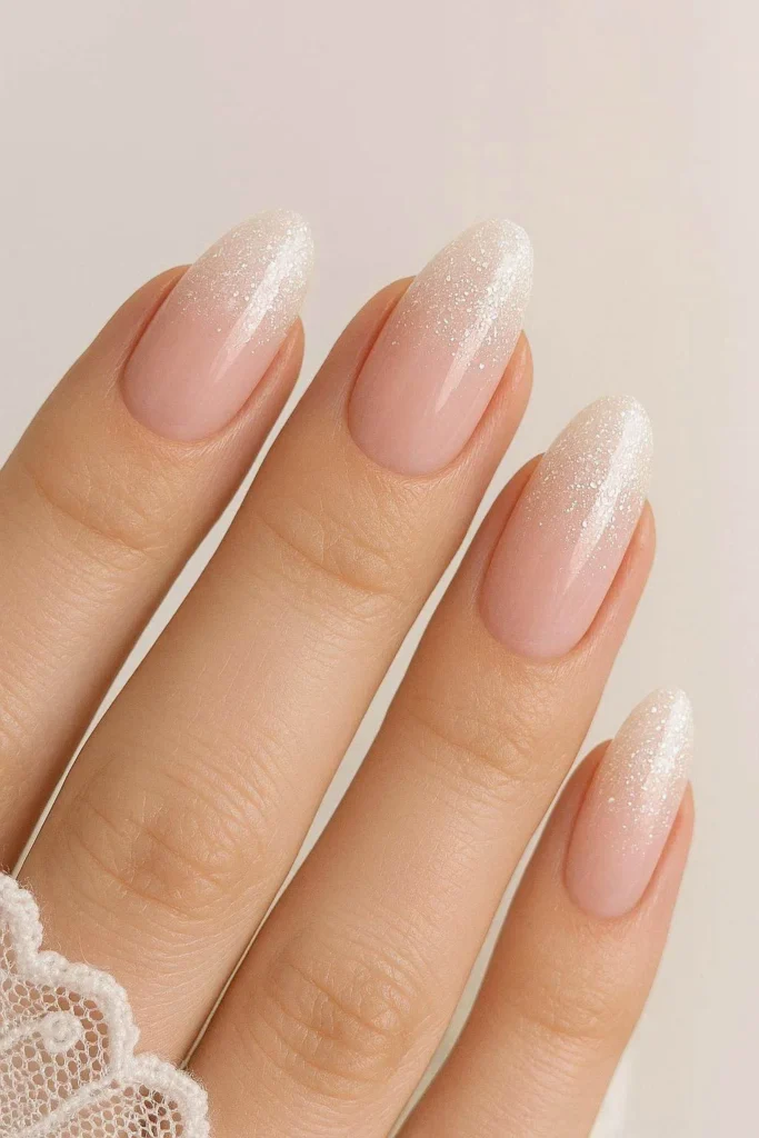 Bridal glitter ombre nails with romantic nude and white shimmer