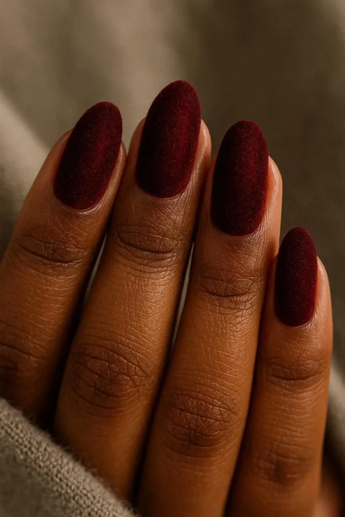  Deep burgundy velvet textured nails on dark skin tones 