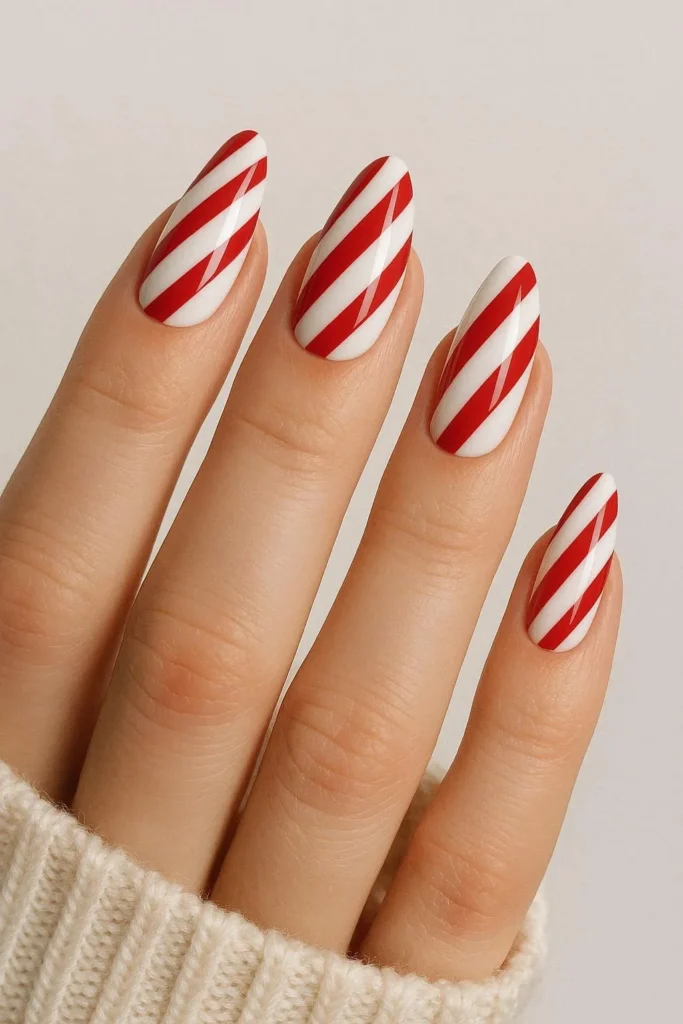 Almond shaped nails with elegant candy cane stripes