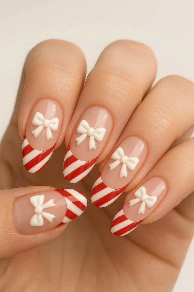 Candy cane French tip nails with cute holiday bow accent nail art