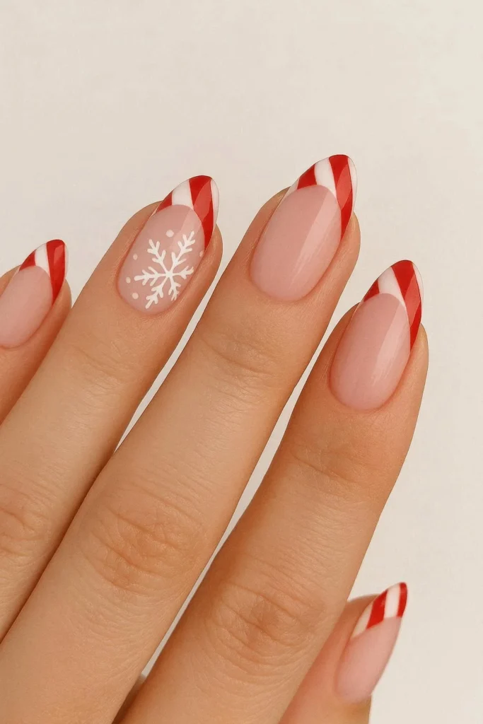 Candy cane French tip nails with tiny snowflake accent design