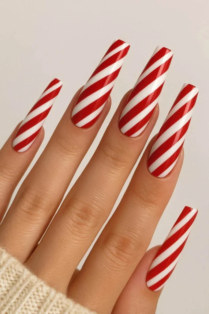 Long coffin nails with bold candy cane Christmas art
