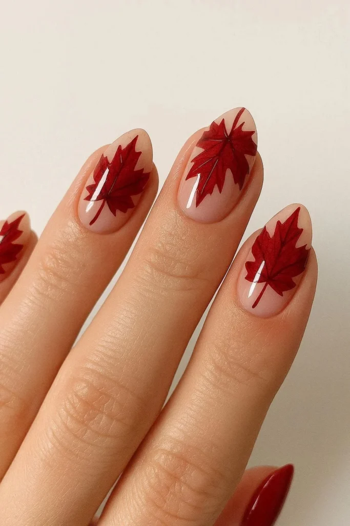 Classic red maple leaf nails on a nude base