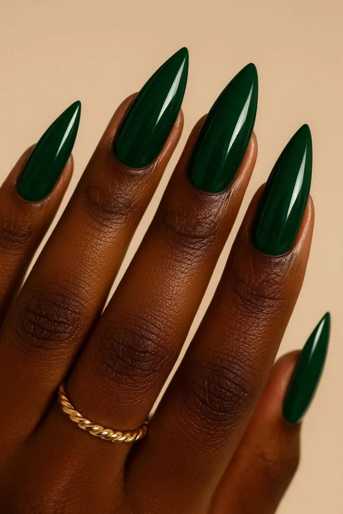 Emerald green glossy almond nails on rich dark skin