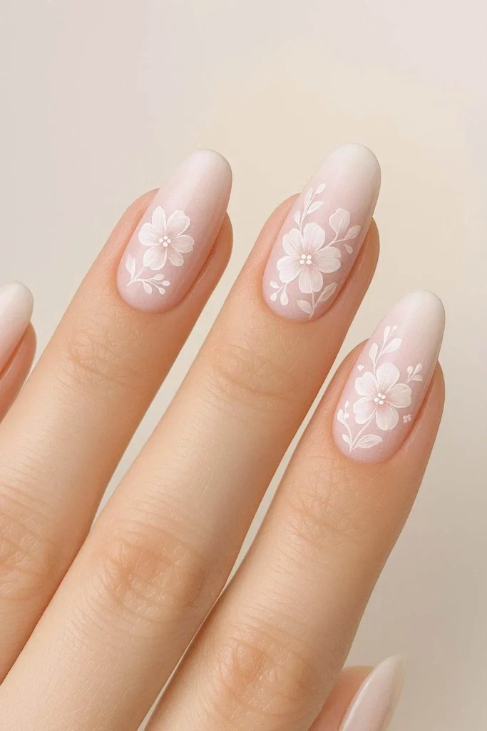 Floral ombre nails with blush gradient and delicate painted flowers 