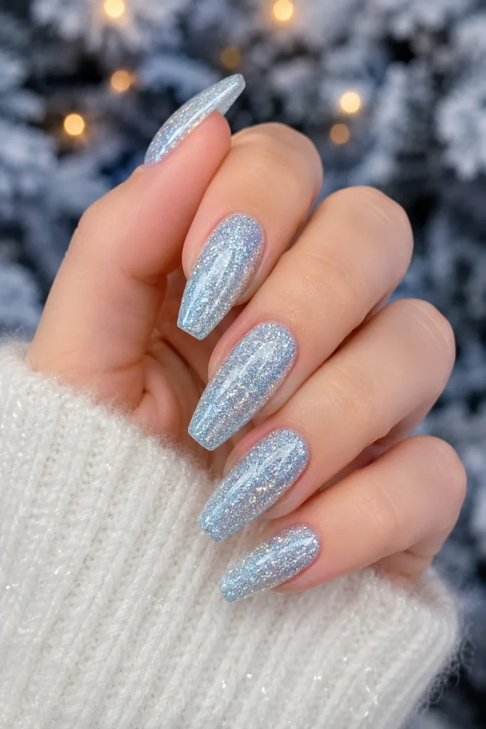 Sparkling icy blue glitter nails mimicking fresh snow shimmer