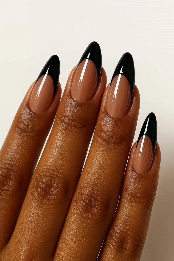  Glossy black French tip almond nails on deep brown skin