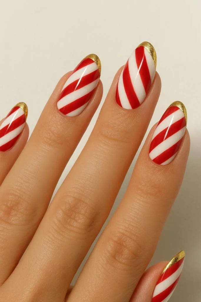Candy cane French tip nails with gold foil accent border detail