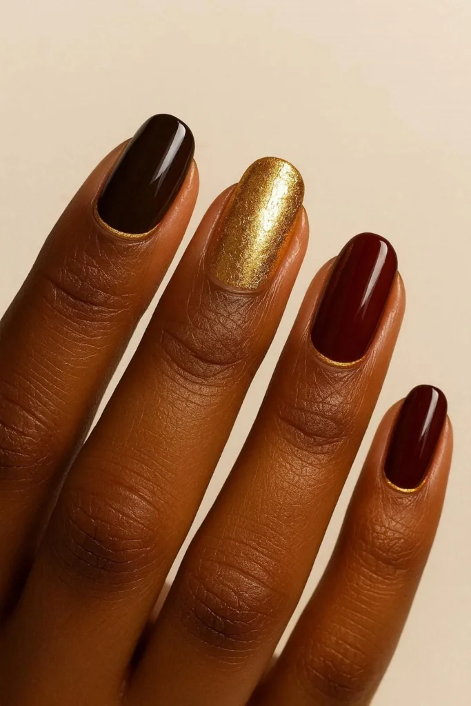 Gold accent fall nails on deep brown skin tones luxe