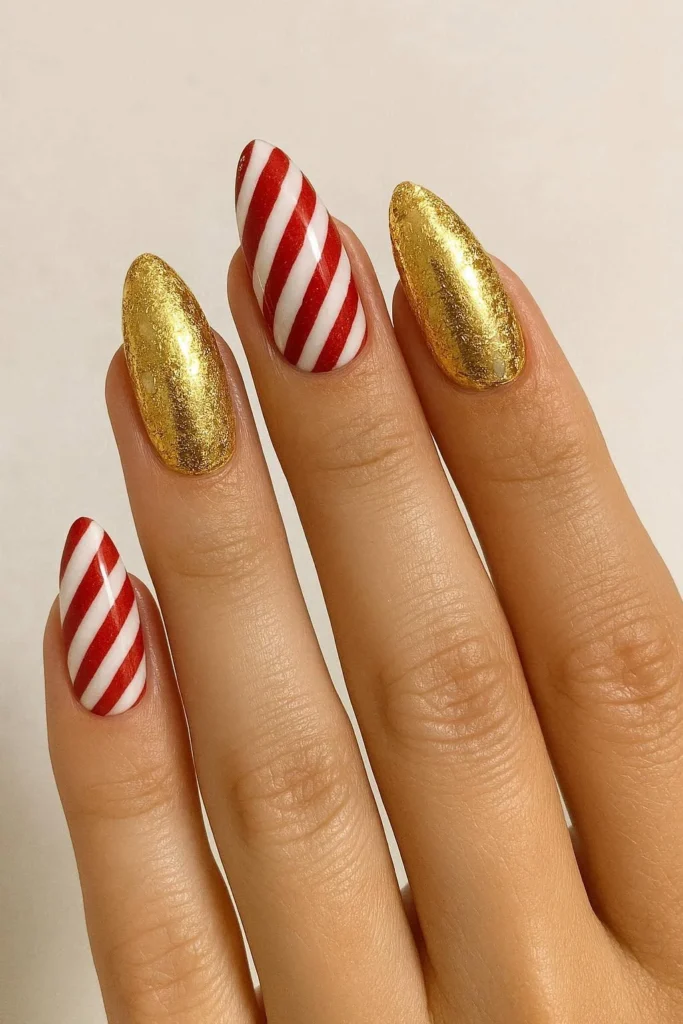 Candy cane nails with festive gold foil accents