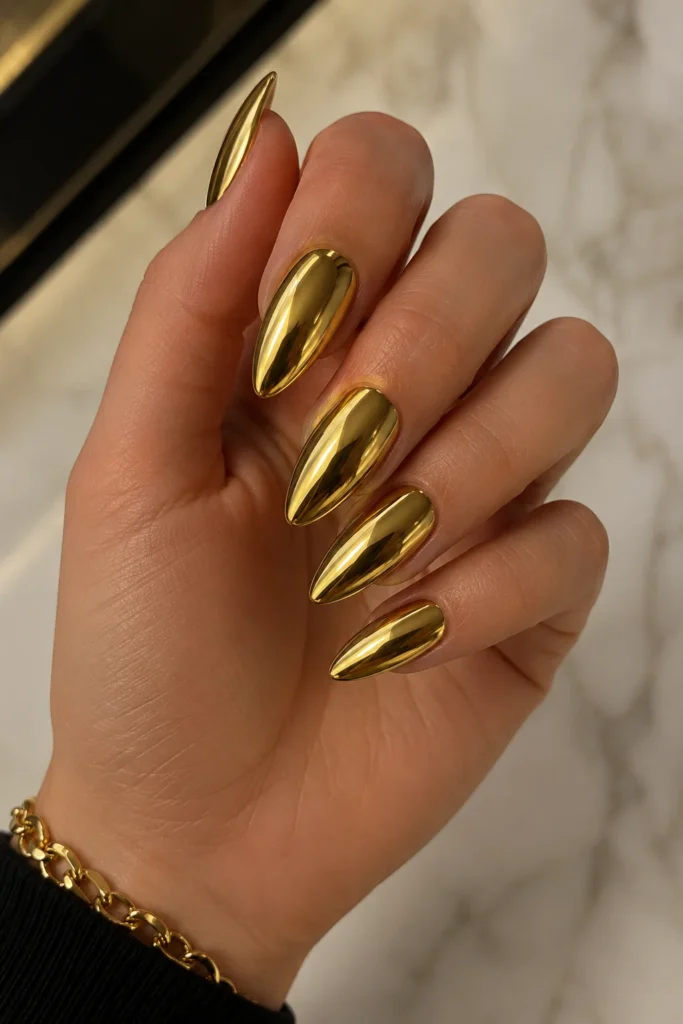 Gold chrome almond nails bold luxury metallic mirror finish