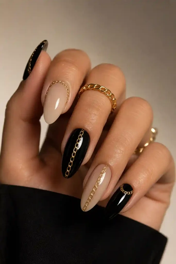 Luxury chain accent nails with gold metallic detail on nude base