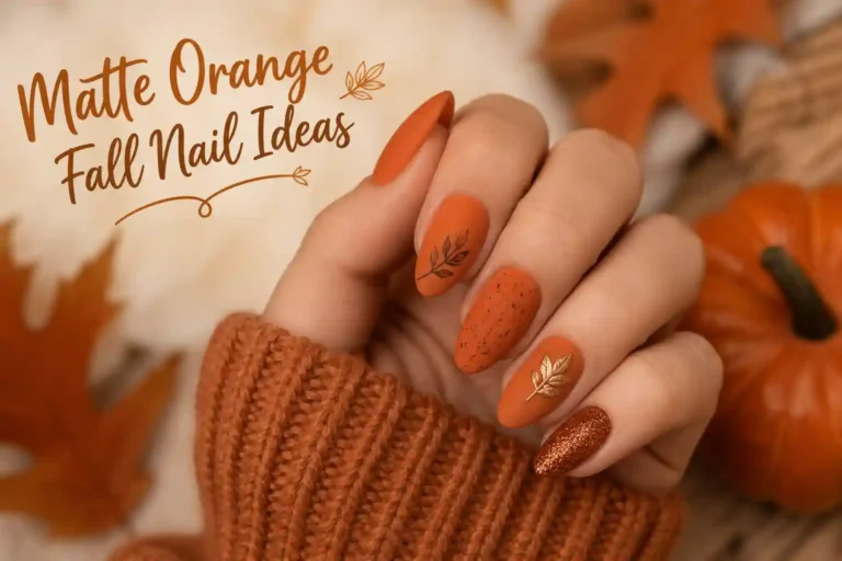 Matte orange fall nails with cozy autumn-inspired leaf and glitter accents