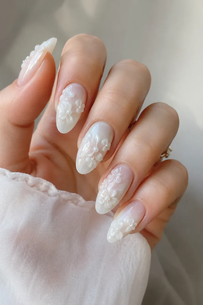 Milky white 3D flower nails with raised sculpted petal details
