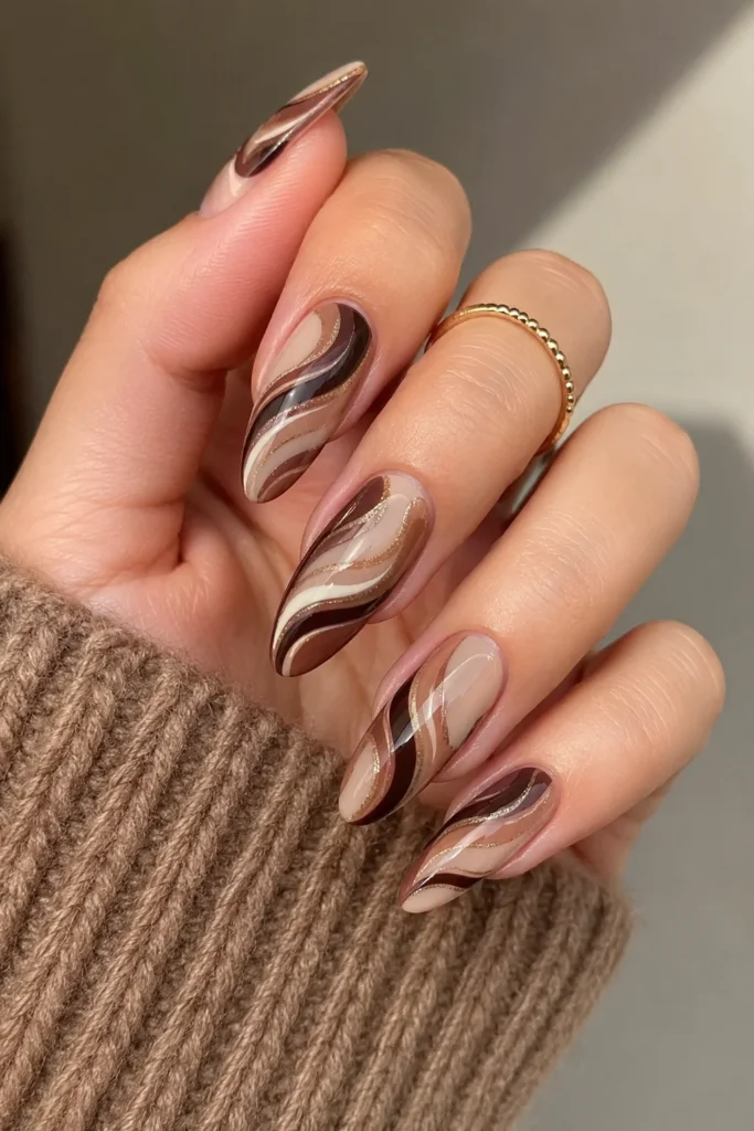 Mocha swirl almond shaped nails in deep brown tones