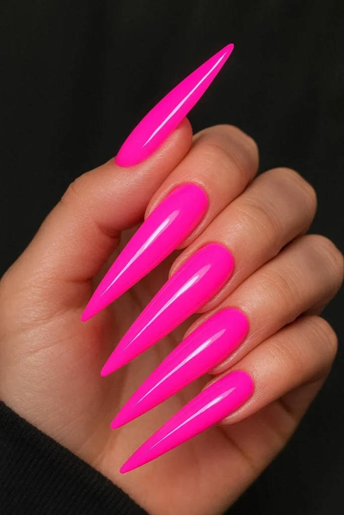Neon pink acrylic nails with electric UV-bright glossy finish