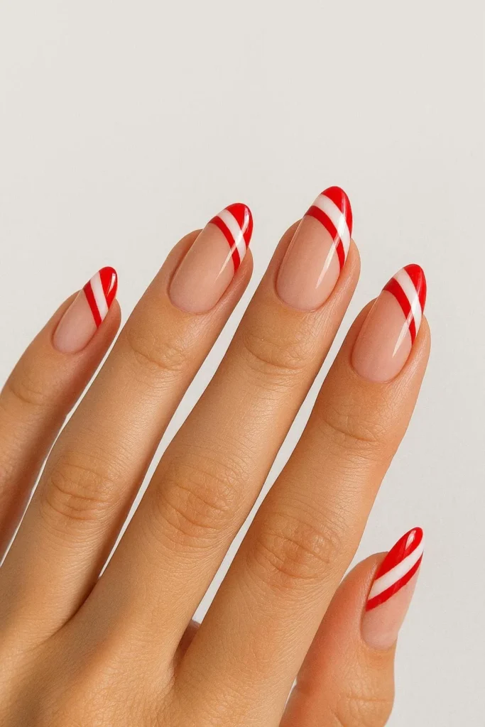 Nude base candy cane French tip nails chic natural holiday design