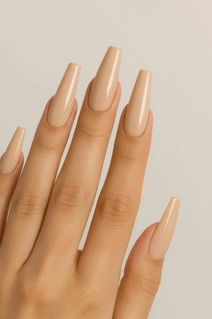 Nude beige coffin nails with sleek long neutral manicure finish