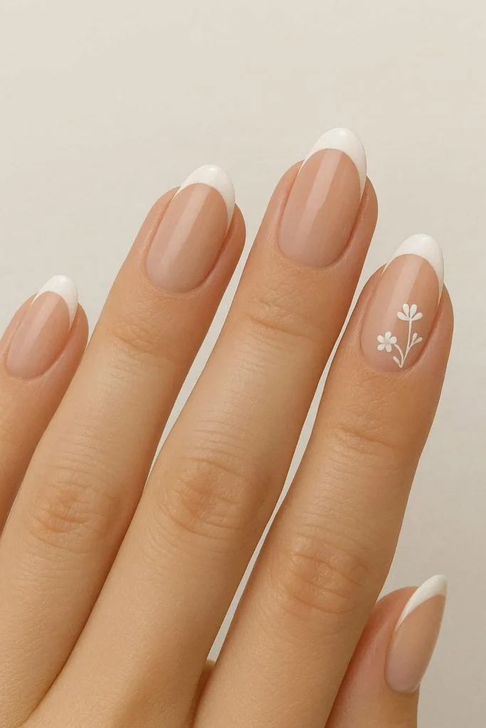 Nude French tips with white wildflower nail art