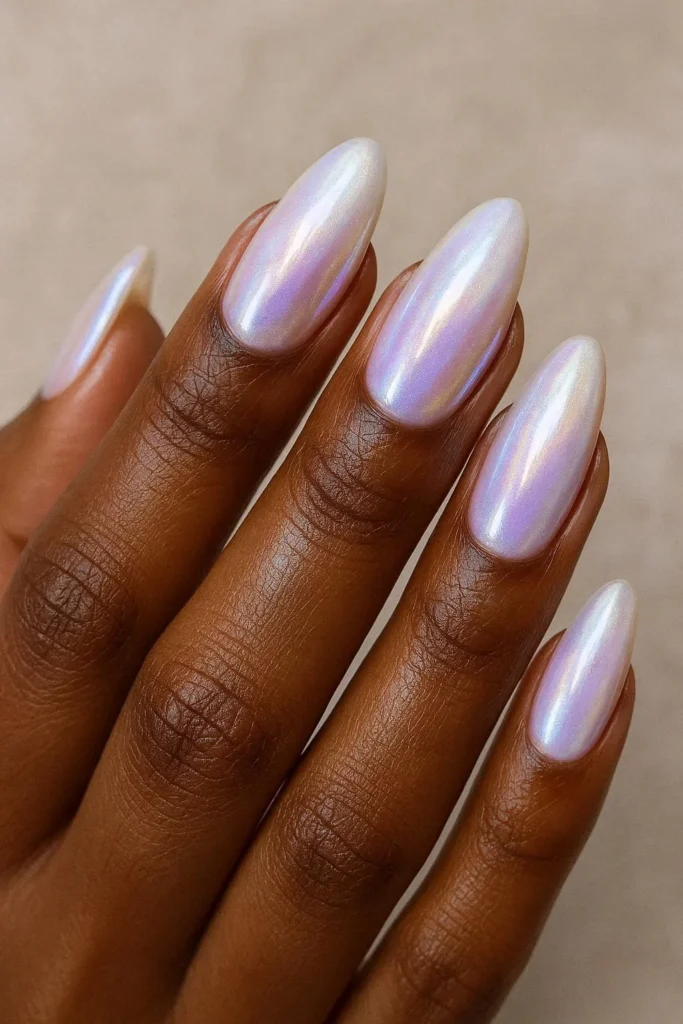 Pearl glazed iridescent oval nails on dark brown skin 
