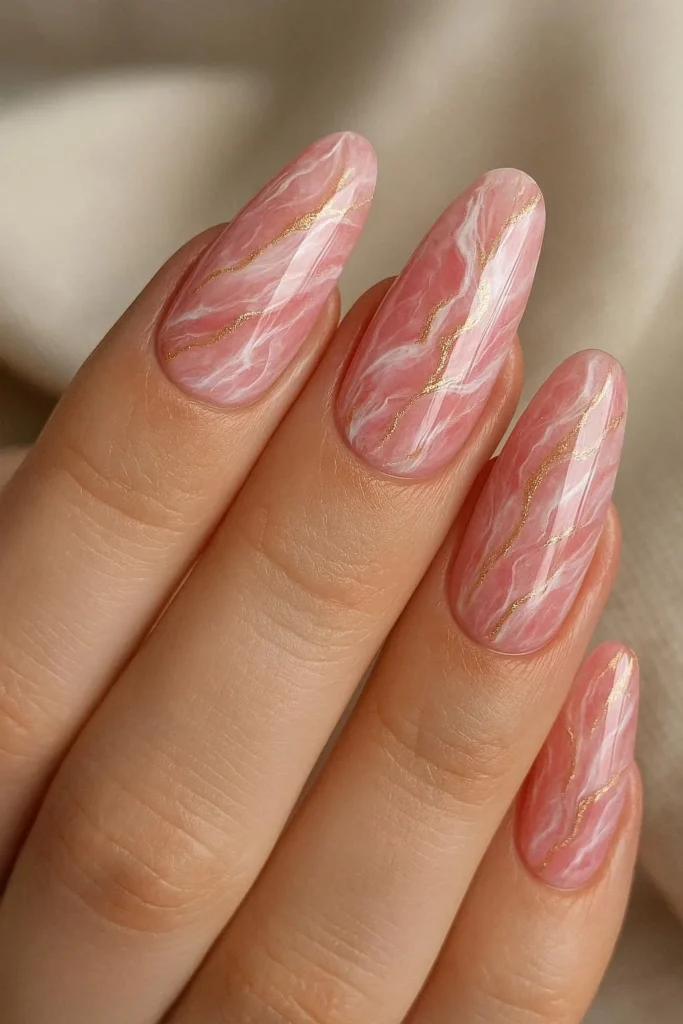 Pink marble acrylic nails with white and gold veining detail 