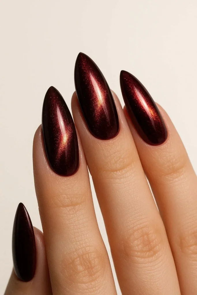  Red wine cat eye nails with garnet gold shimmer on almond shape