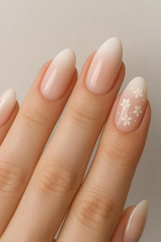 French ombre nails with tiny painted blossom accents