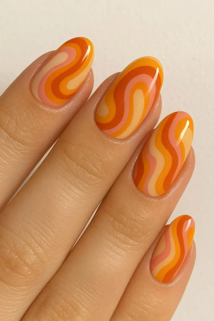 Retro sunset swirl nails in orange yellow and pink tones