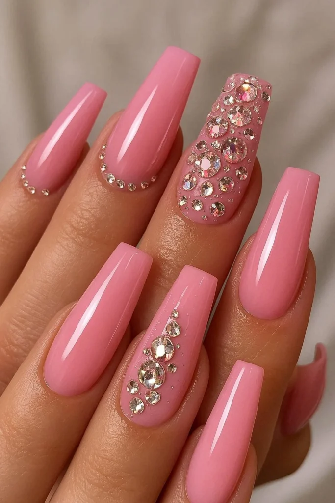 Rhinestone pink acrylic nails with crystal gem embellishment detail