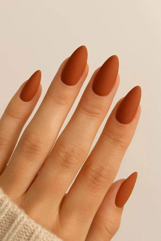 Rust orange almond shaped matte nails for elegant autumn manicure