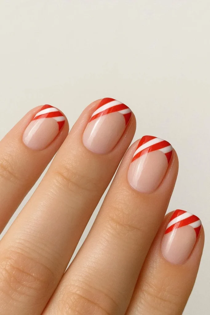 Short candy cane French tip nails playful red white stripes