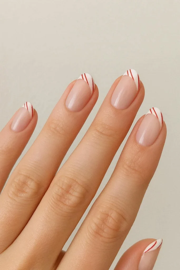 Minimalist thin candy cane French tip nails delicate red white