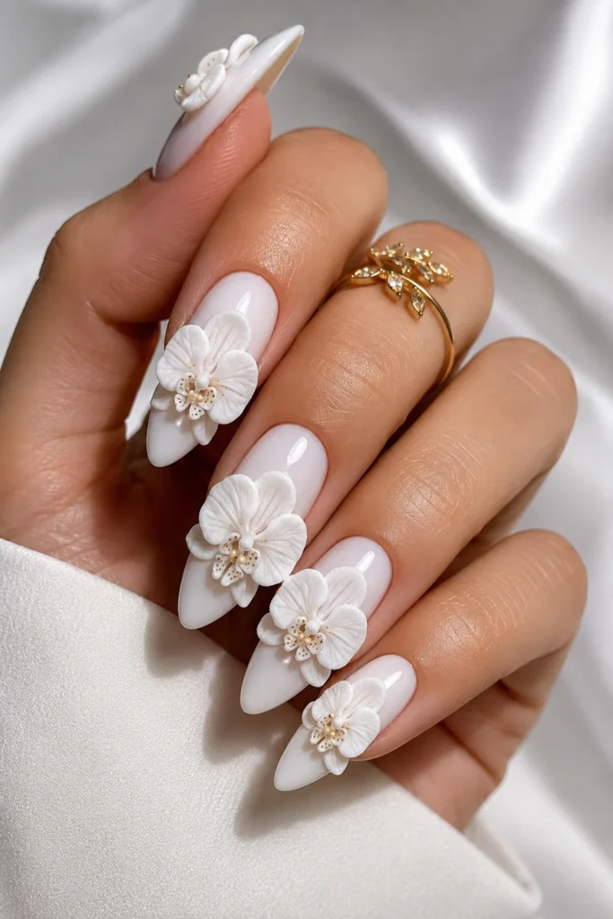 White orchid 3D nail art with sculptural raised petals on glossy base