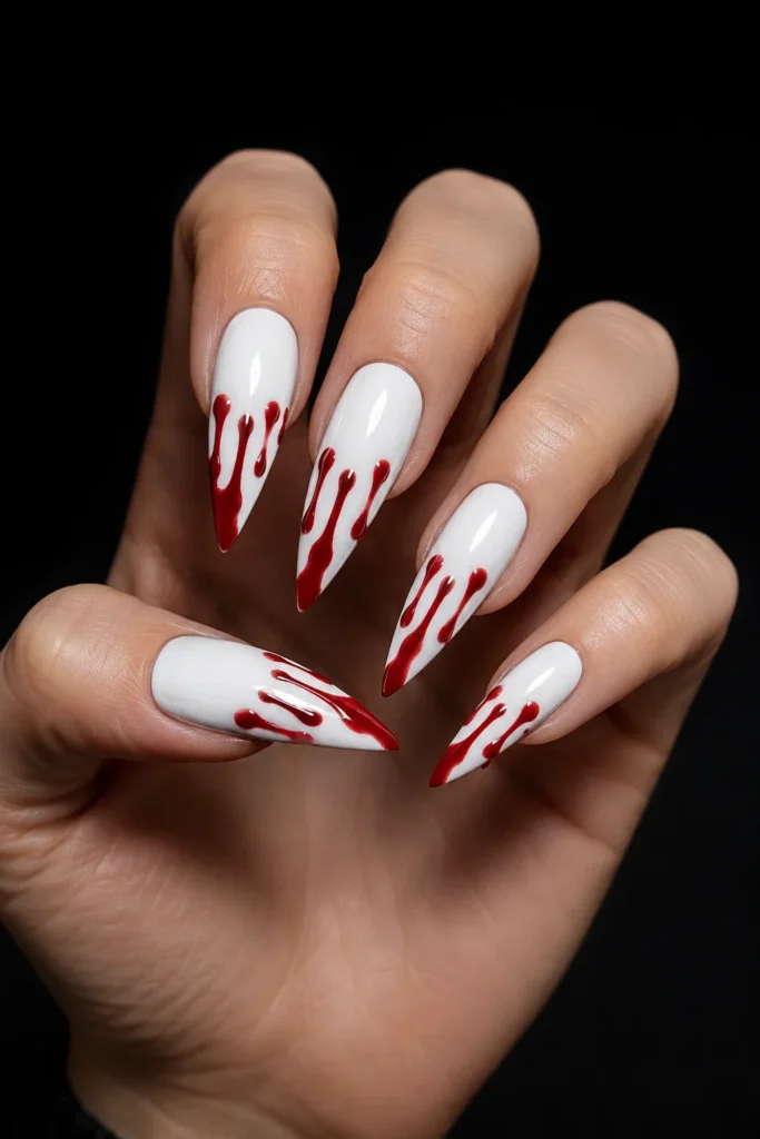White nails with bold red blood drip nail art 