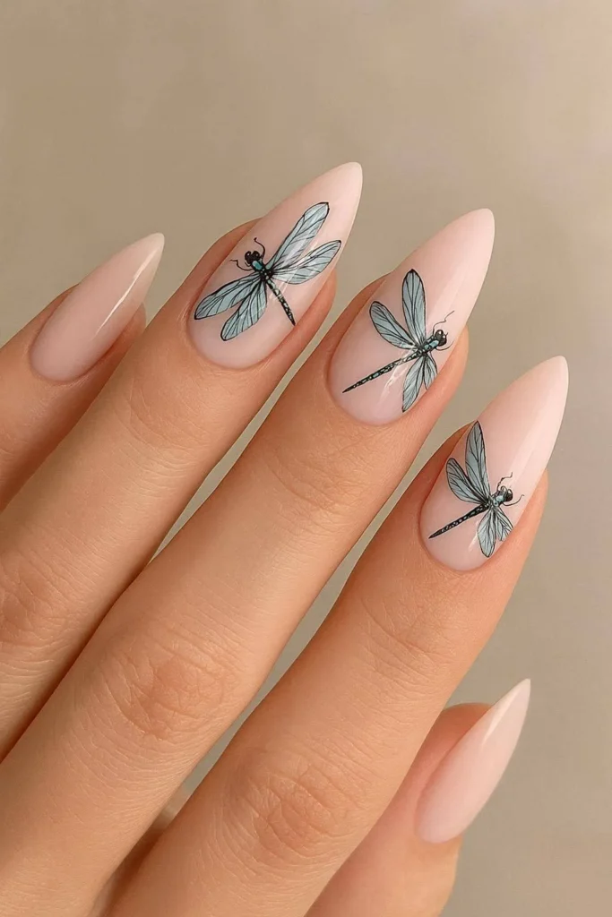 Almond shaped nails with detailed dragonfly artwork