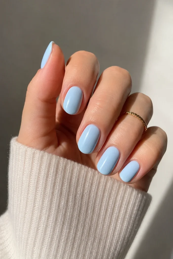 Pastel baby blue polish on clean simple nails