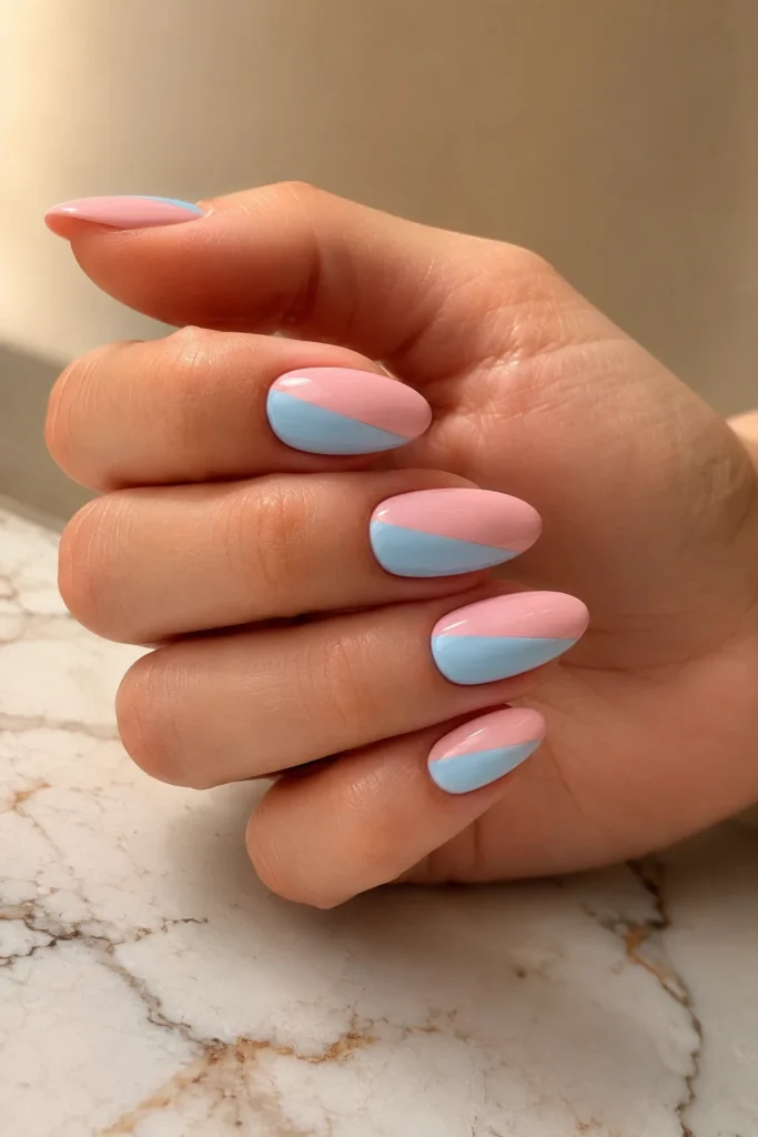 Baby pink and sky blue split nail design with glossy finish