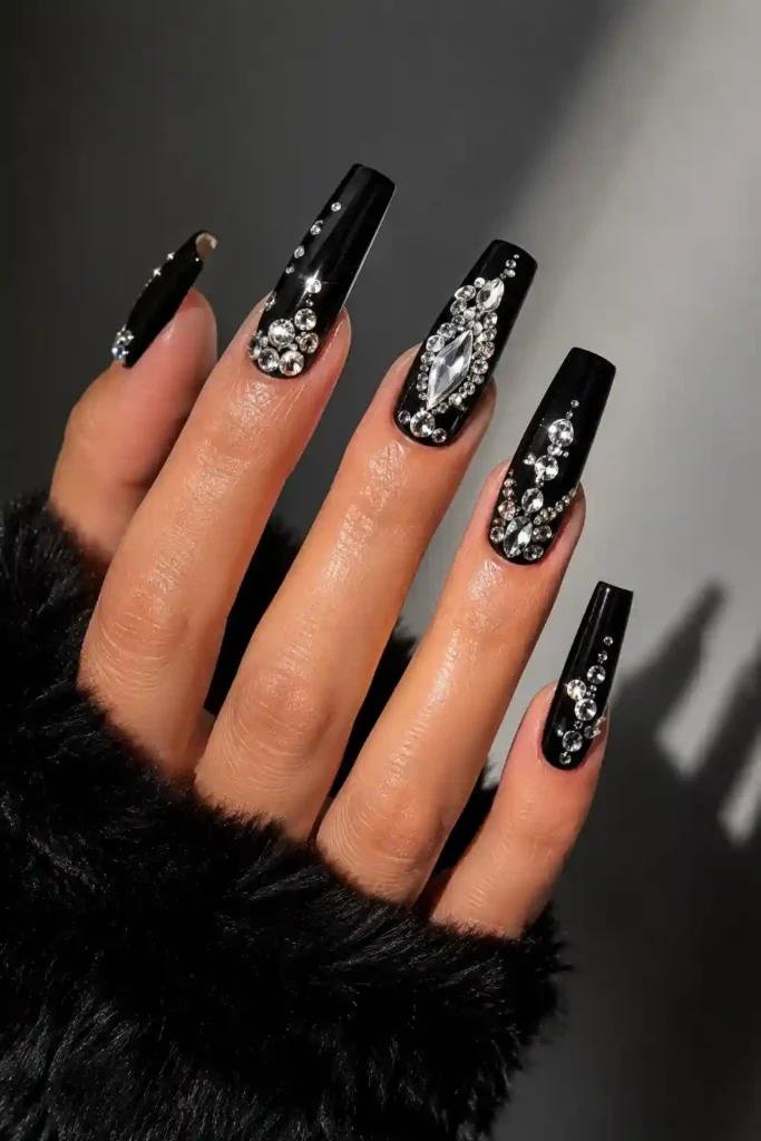 Glossy black nails contrasted with bright sparkling rhinestone crystals