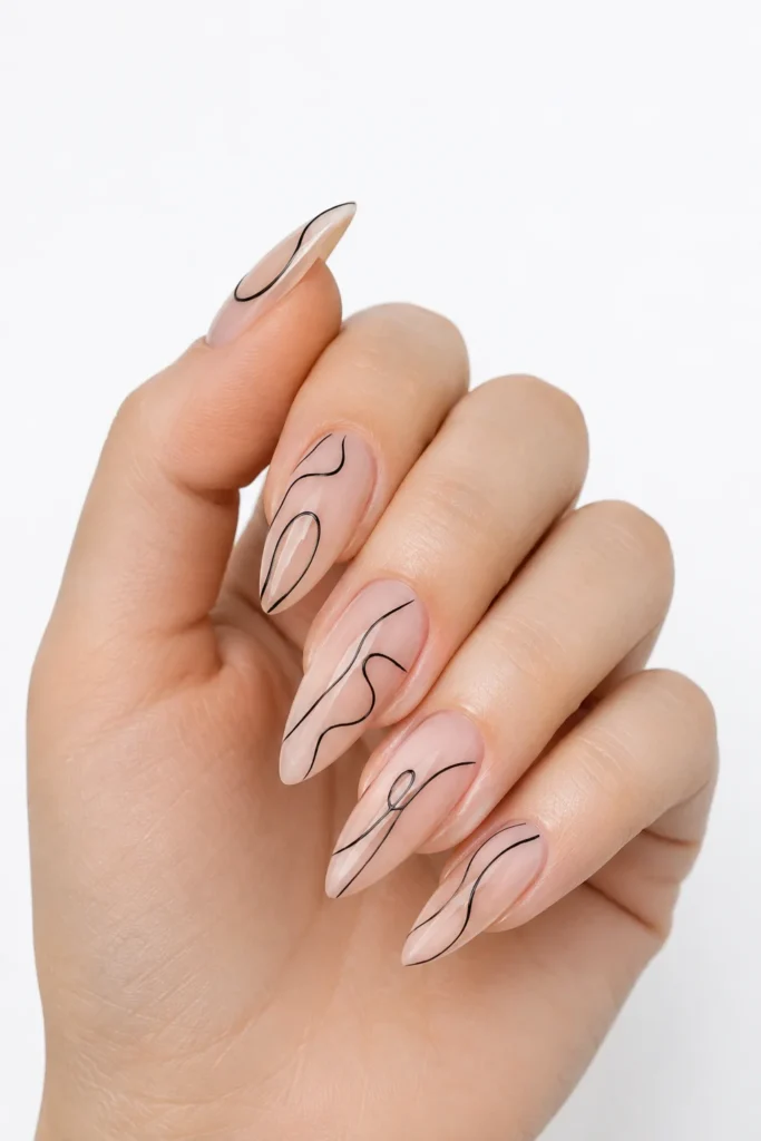 Minimal black line art on nude pointy nails with glossy finish