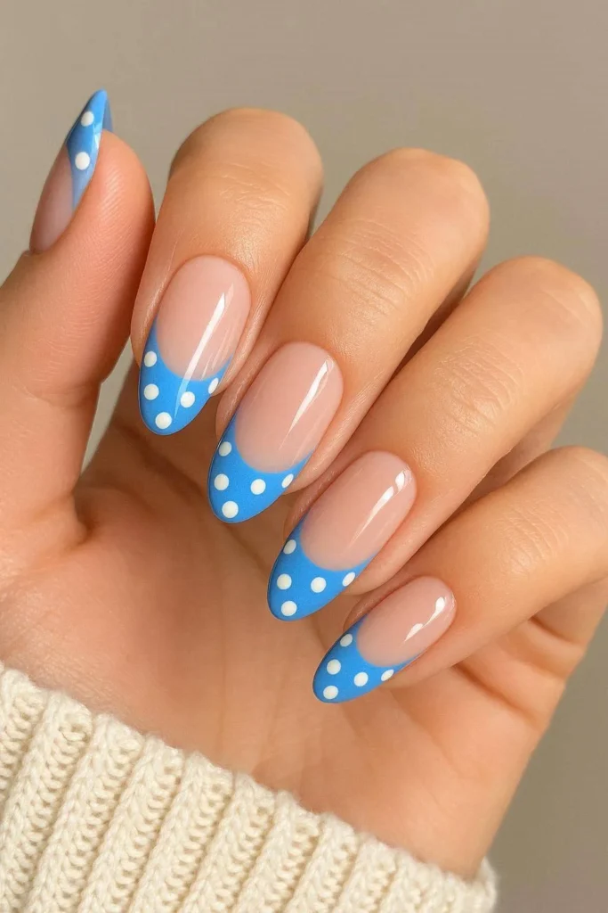 Blue French tip nails with white polka dots