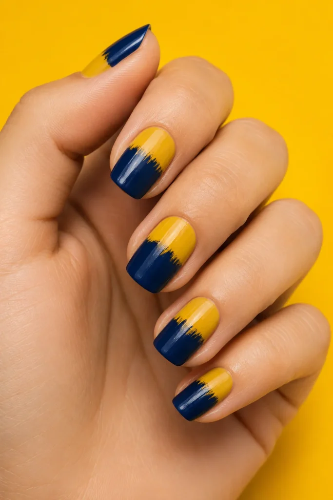 Bold color block brushstroke nail design in mustard and navy