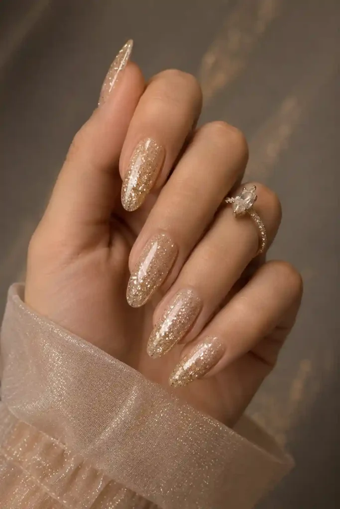 Neutral champagne toned nails with luxurious glitter sparkle