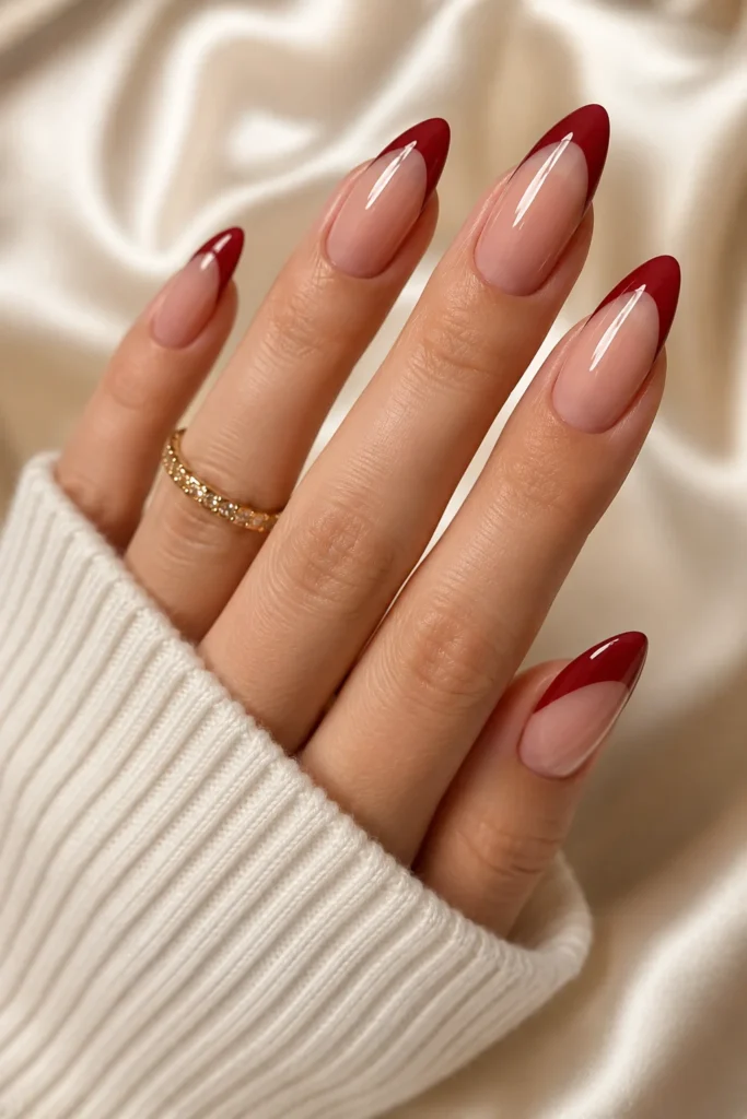 Deep cherry red French tips on almond nails