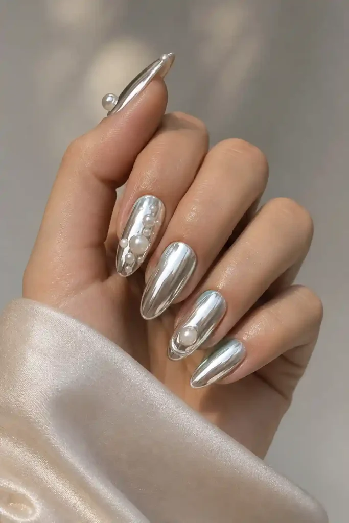 Modern chrome nails paired with soft elegant pearl embellishments