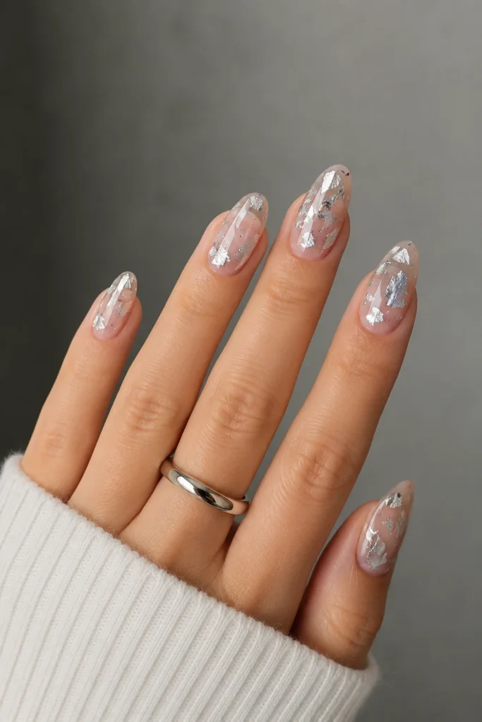 Clear nails with asymmetrical silver foil shard details