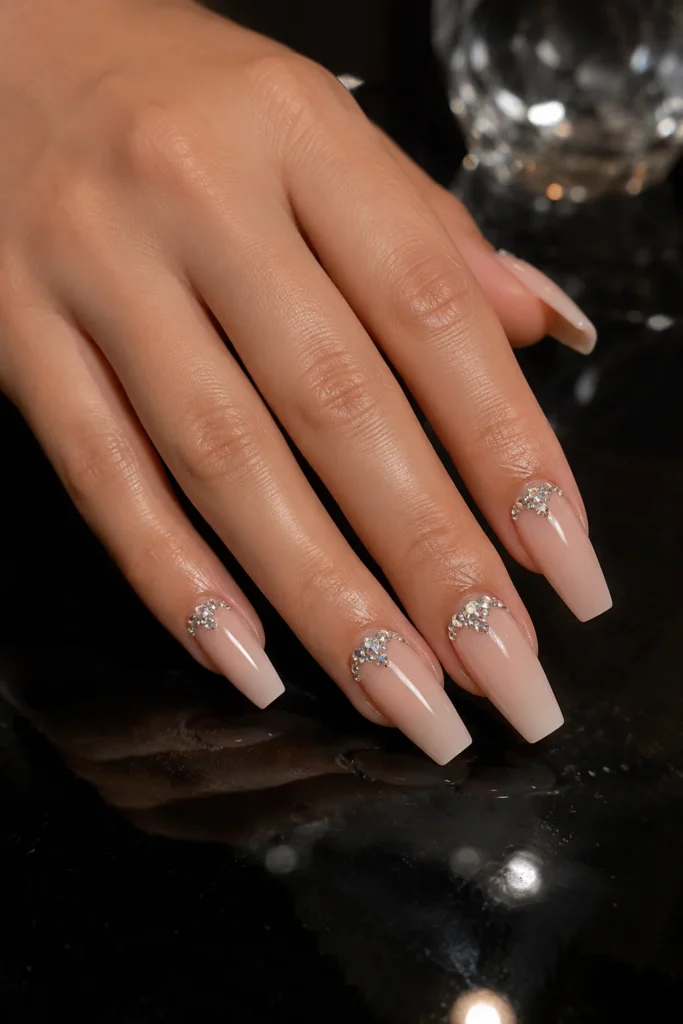 Nude ballerina nails with crystal cluster accents