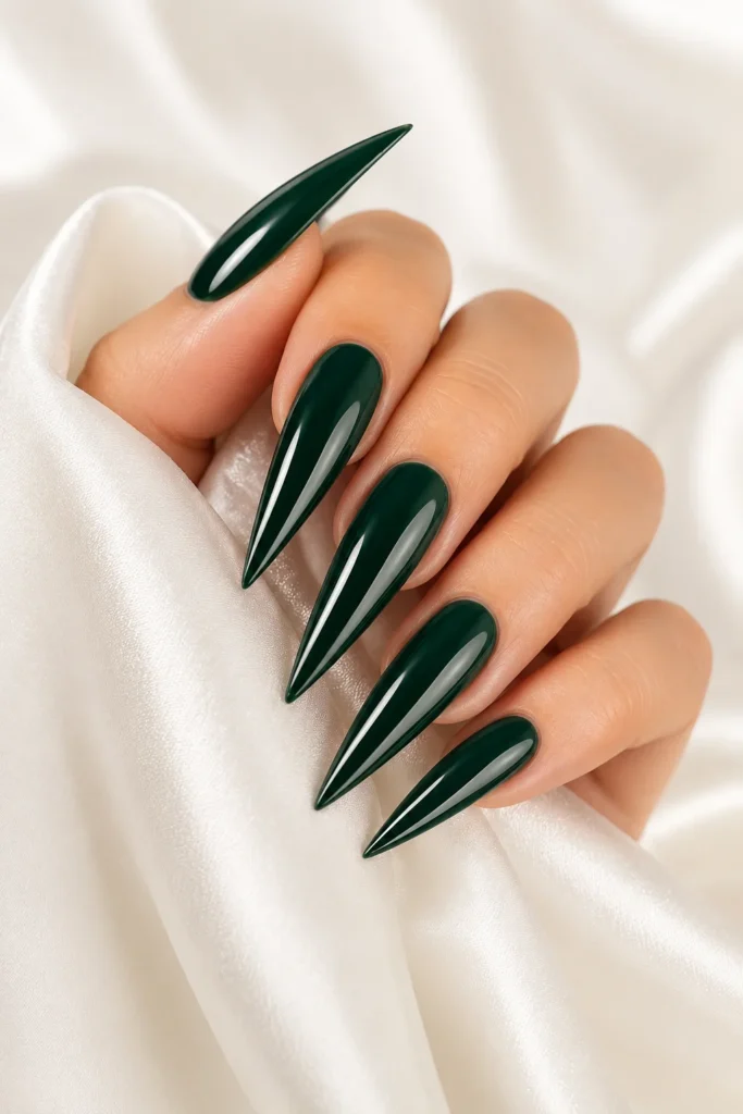 Long stiletto pointy nails painted in deep emerald and wine shades