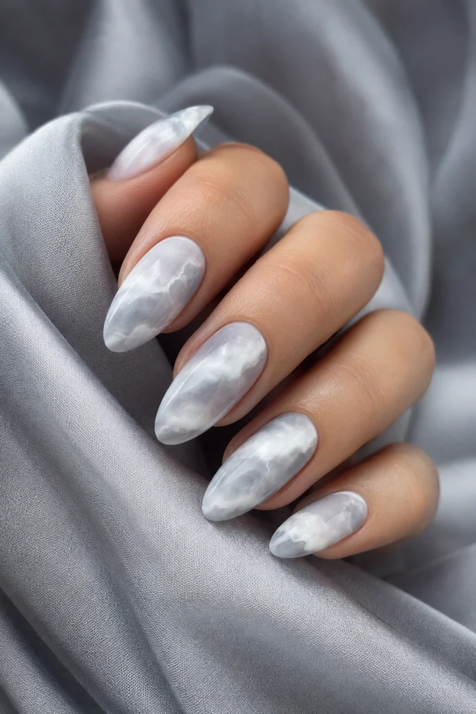 Cloud marble effect dip powder nail design.