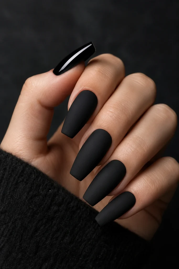 Matte black dip powder nails with glossy tip.